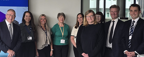 David Garbutt welcomes Ms Minto (third from the right at the front, next to Lee Savarrio, second from the right) along with NES colleagues.