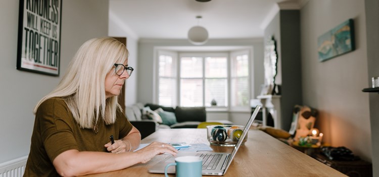 New tool to support careers in social care image A woman looking at a laptop at home image