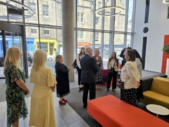 NES Chair David Garbutt, centre, welcoming the visiting delegation.
