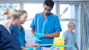 Male and female nursing staff on a hospital ward image